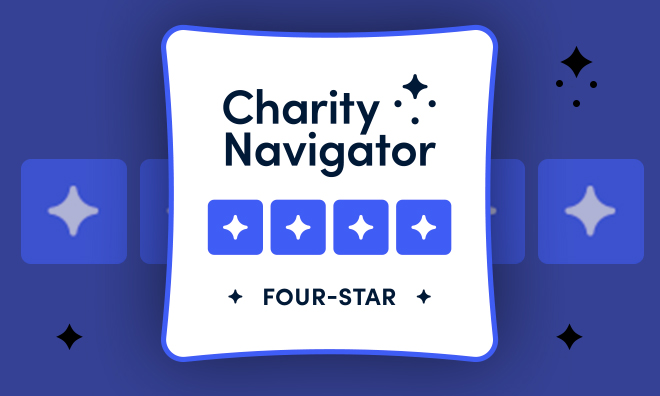 The Charity Navigator Certified four stage badge, consisting of the Charity Navigator Logo with four sparkles in the upper right corner. Below the logo sit four blue stars, the highest rating possible from Charity Navigator's scoring system. 