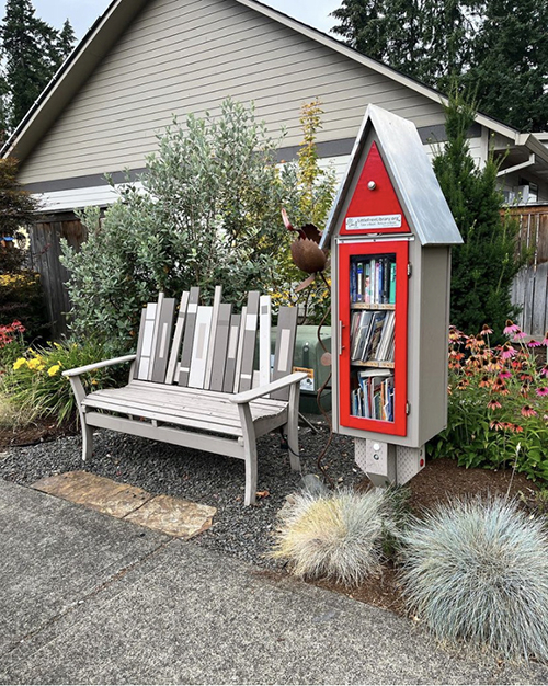 Little Library book shelf next to a bench