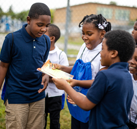 Group of children reading outside together