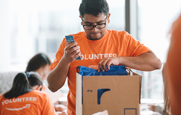 Amazon and RIF partnership boy opening box of books