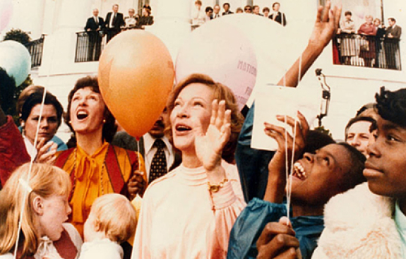 Photo of Rosalynn Carter with balloons and kids